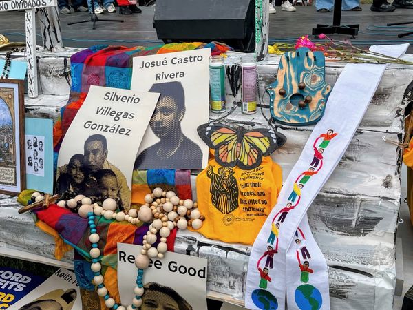 An altar with photos, artwork, candles and beads pays tribute to victims of ICE.