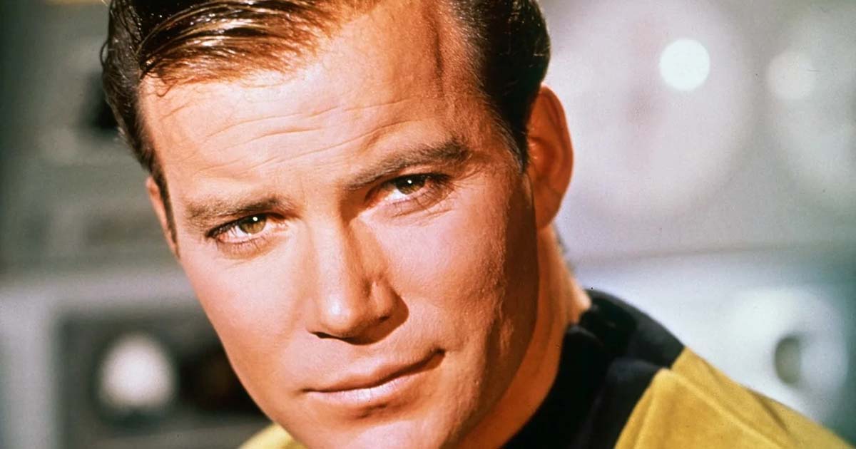 William Shatner as Captain Kirk, looking serious in his gold Starfleet uniform.