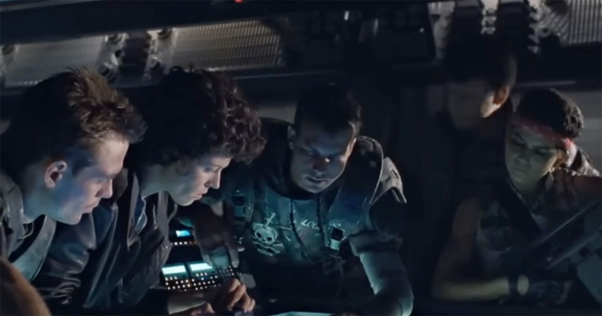 Hicks, Ripley, and Marines studying a map in low lighting.