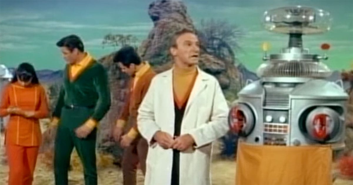 Image from "Lost in Space" showing Dr. Robinson, Major West, Penny Robinson and Dr. Smith on a planet.