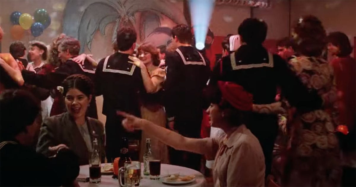 Image of a Night Club with sailors and nurse dancing.