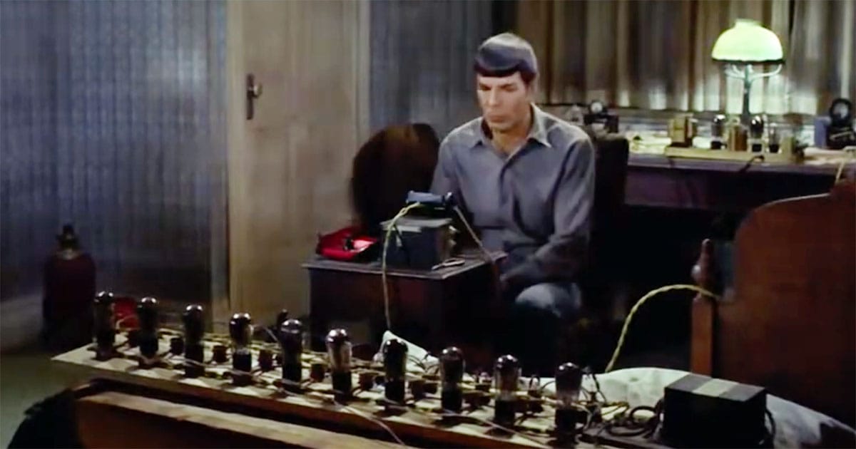 Spock sits at a desk, working on a homemade tricorder using vacuum tubes in "The City on the Edge of Forever."