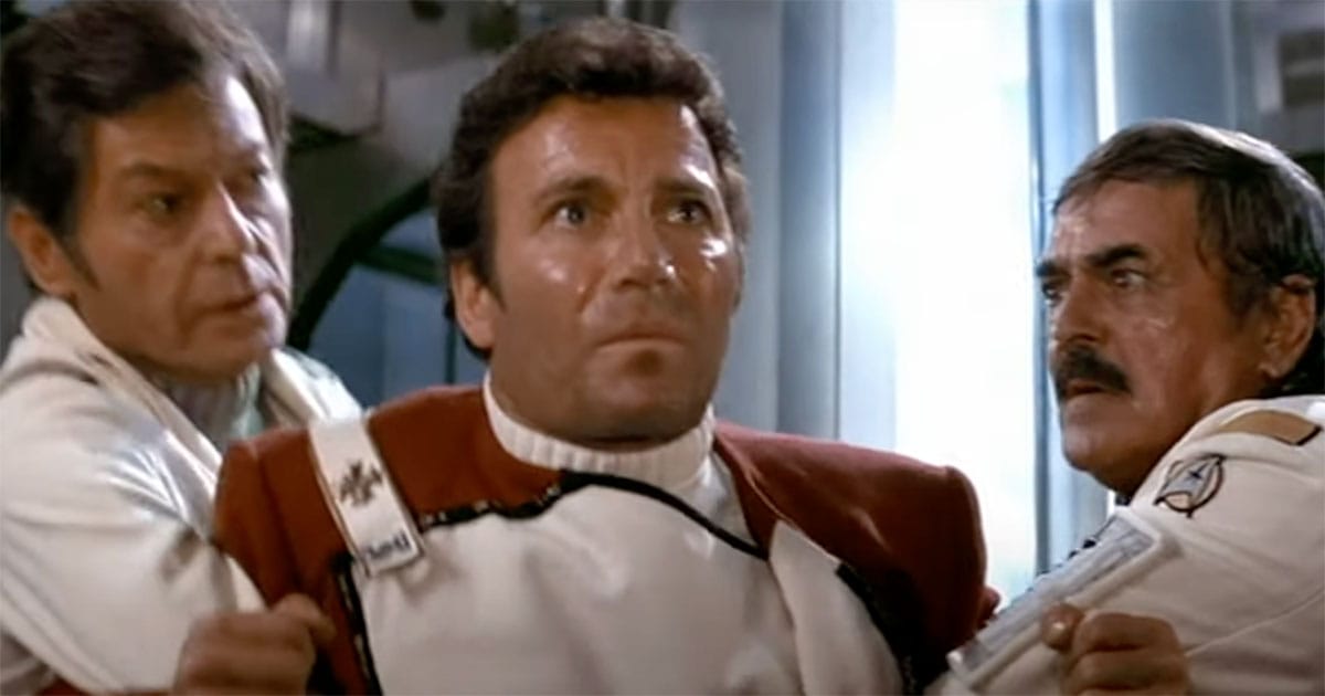 Captain Kirk with Dr. McCoy and Scotty in tense scene from "Star Trek II."