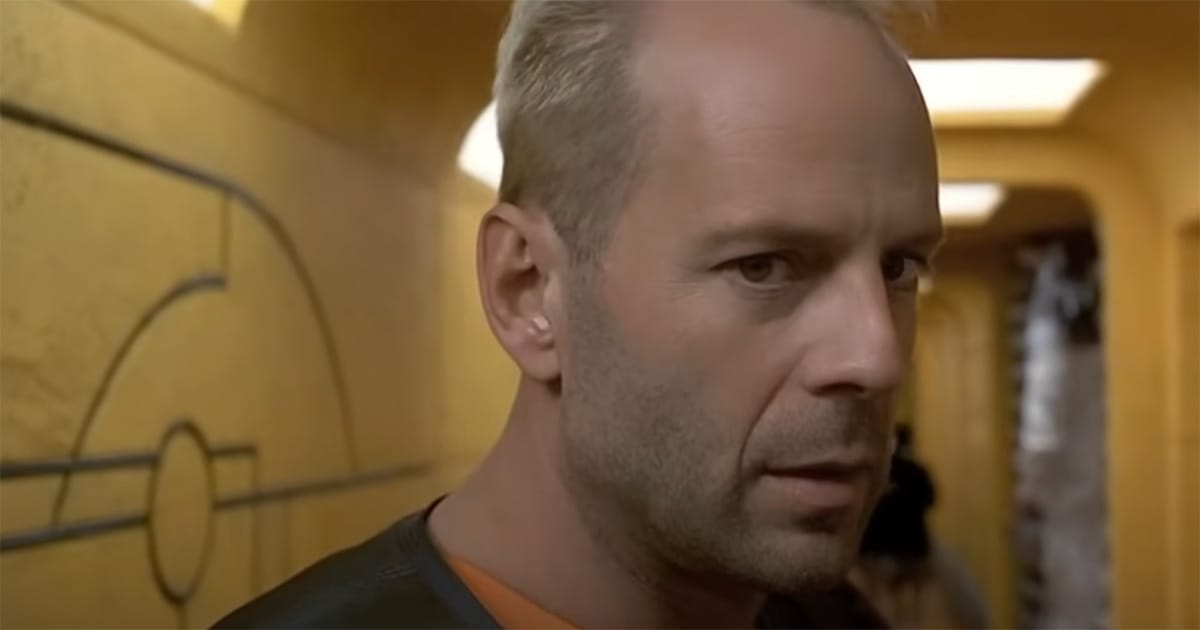 Korben Dallas (Bruce Willis) looks tense in a yellow corridor in "The Fifth Element."