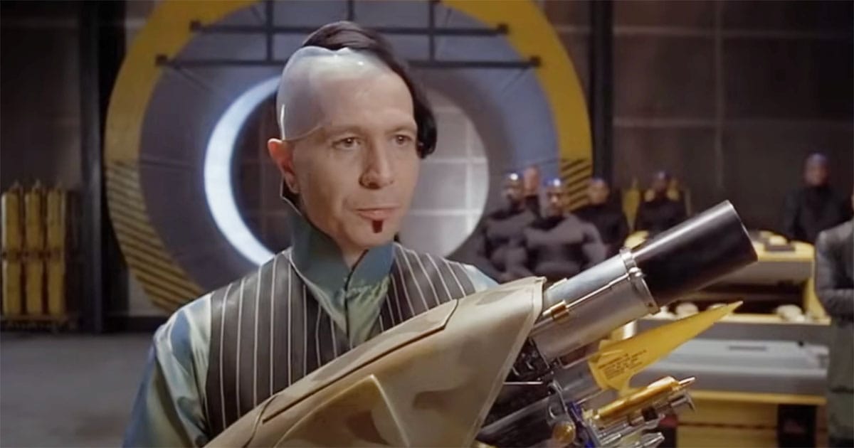 Zorg presenting a high-tech gun to alien mercenaries in "The Fifth Element."
