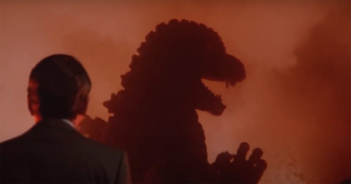 A man watches as Godzilla’s silhouette looms through fire and smoke in "The Return of Godzilla."