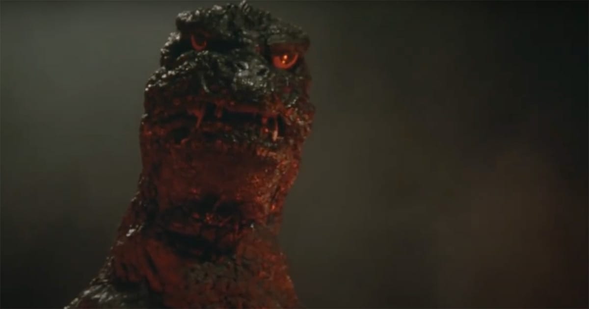 Close-up of Godzilla’s glowing eyes and scorched skin in "The Return of Godzilla" as smoke rises around him.
