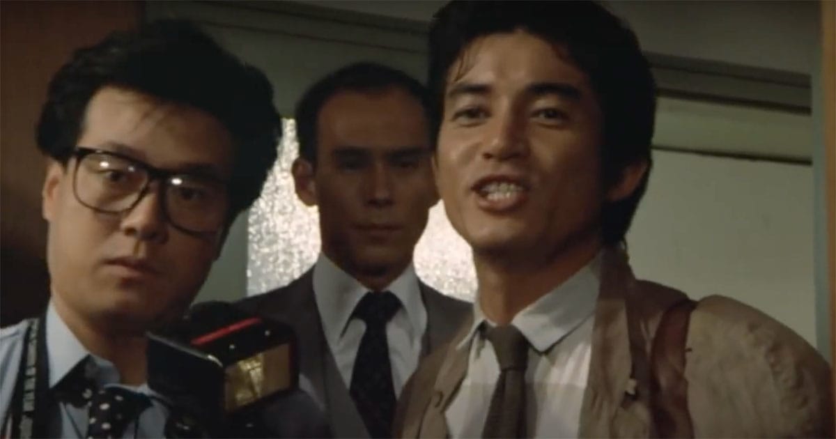 Goro Maki, the reporter, speaks with urgency while cameras capture his arrival in "The Return of Godzilla."