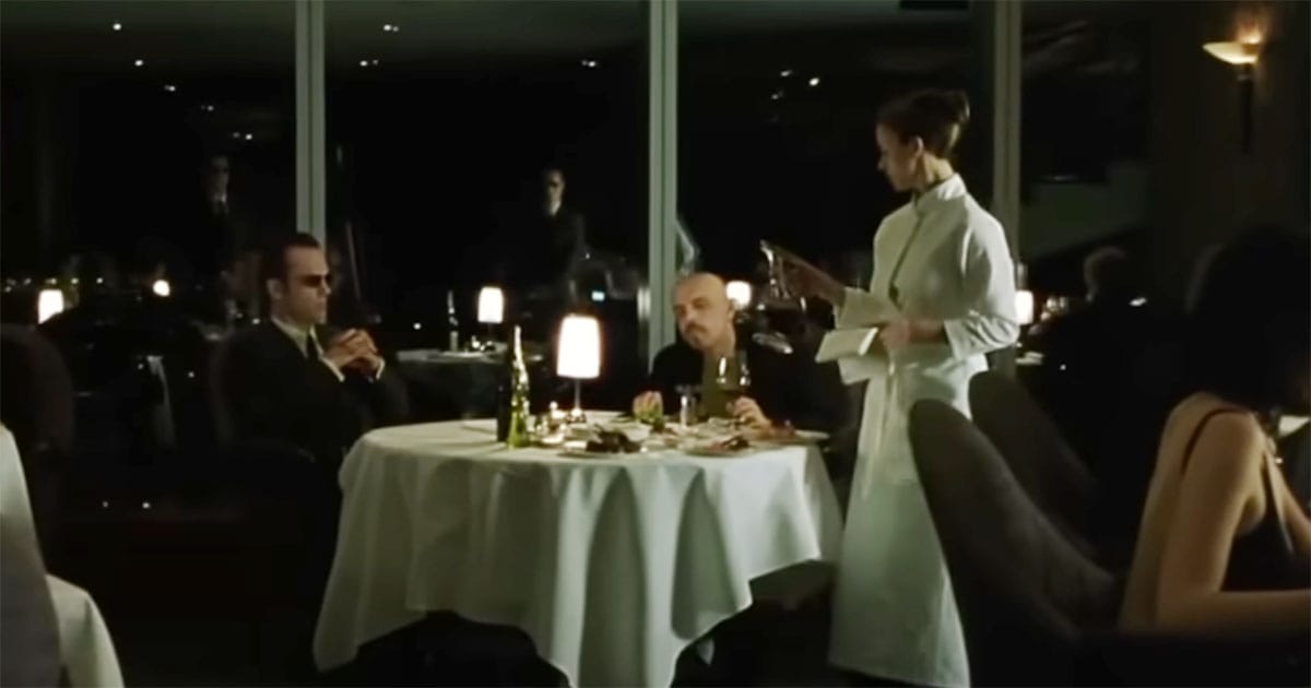 Cypher meets with Agent Smith in a restaurant inside the Matrix to arrange his betrayal.