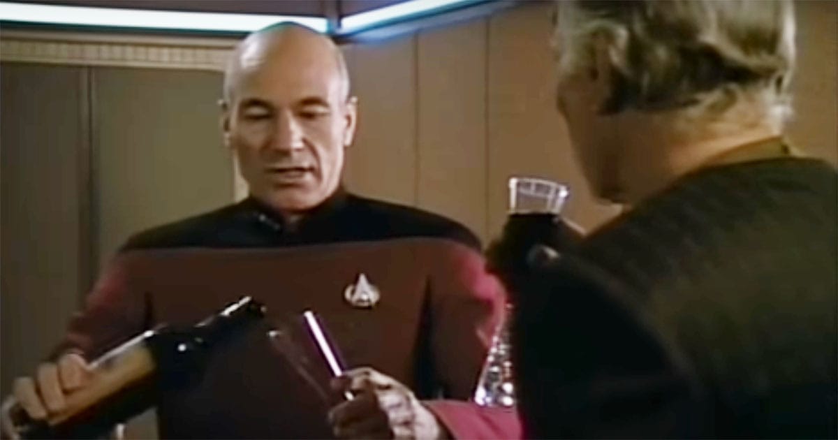 Picard pouring wine for a guest aboard the Enterprise