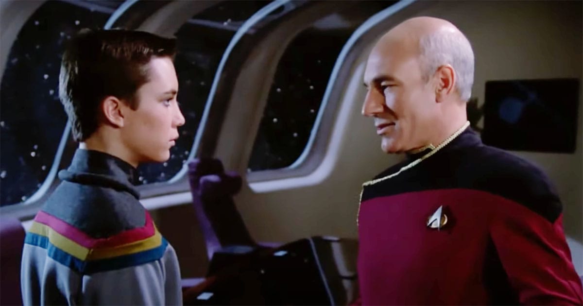 Captain Picard speaking thoughtfully to Wesley Crusher on the Enterprise.