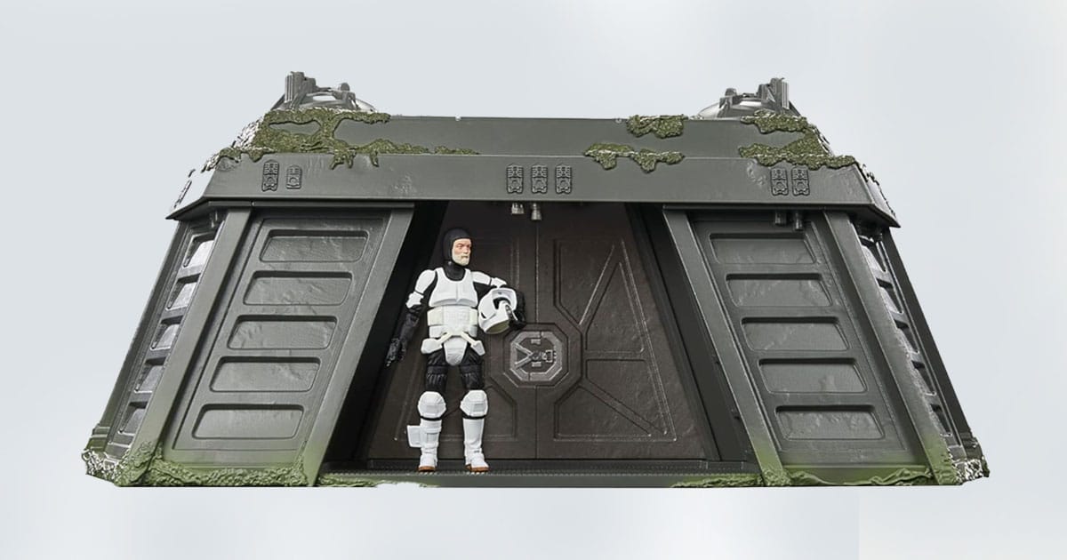 Star Wars action figure of a clone trooper in front of a moss-covered bunker playset.