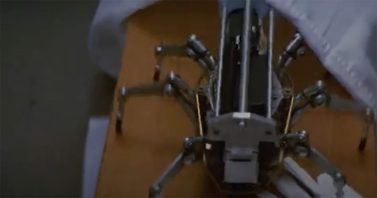 Close-up of a robotic spider assassin emerging from under a blanket in the film "Runaway."