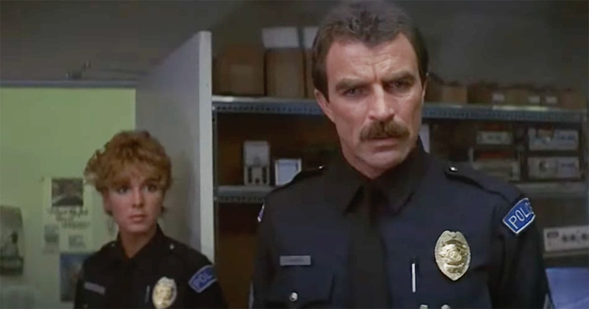 Tom Selleck and Cynthia Rhodes as futuristic police officers surveying a crime scene in the film "Runaway."