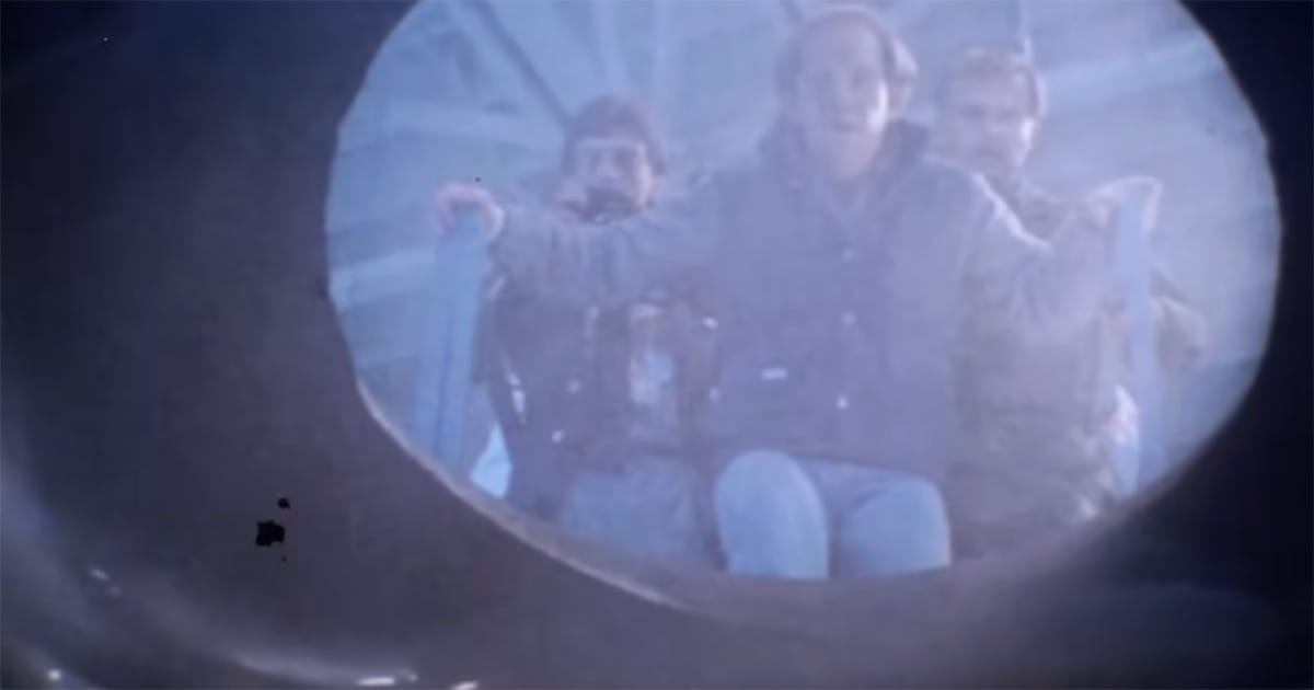 Scientists looking into the alien ship in a key moment from "Starman" where observation replaces fear.