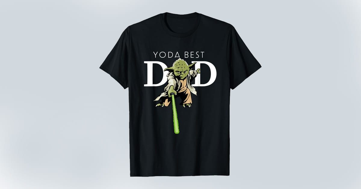 Black T-shirt featuring an illustration of Yoda with a green lightsaber and the phrase "Yoda Best Dad" in bold white text.
