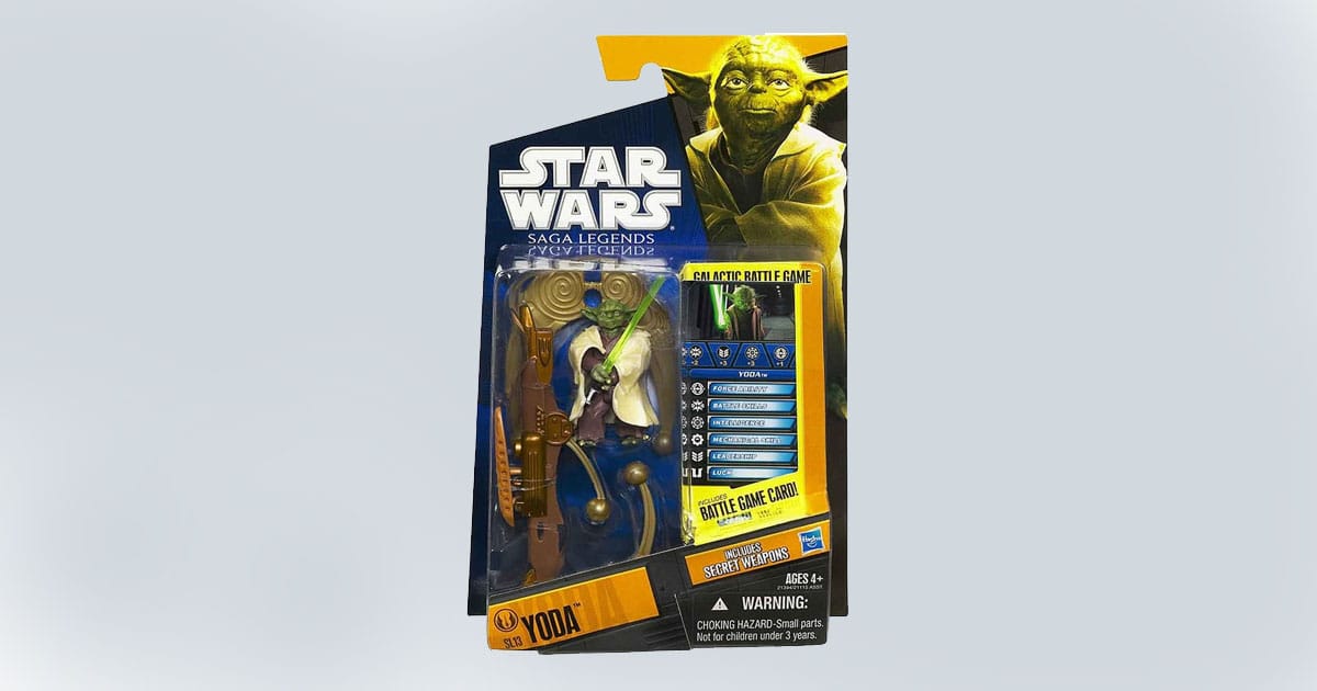 Packaged Yoda action figure from Hasbro’s Star Wars Saga Legends line, including a projectile-firing catapult and Galactic Battle Game card.