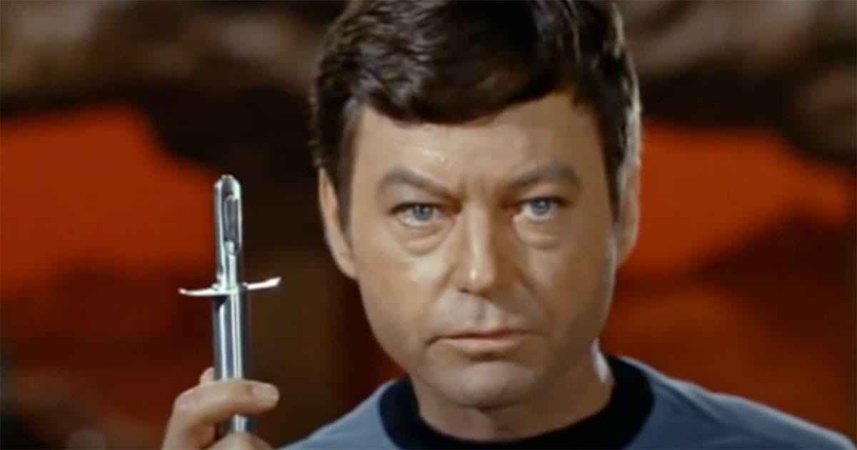 Dr. McCoy holding a hypospray in "Star Trek: The Original Series," showcasing a futuristic needle-free medical device.