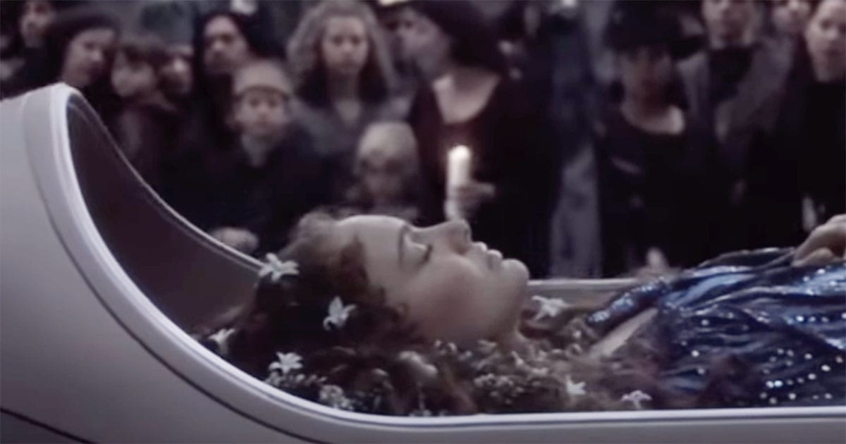 Padmé Amidala lying in state during her funeral procession in "Revenge of the Sith," surrounded by mourners on Naboo