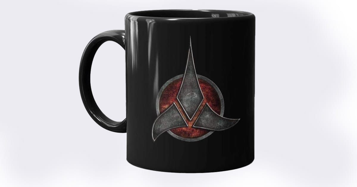 Black ceramic mug featuring the Klingon Empire emblem from "Star Trek," with a red circular background and a sturdy handle.