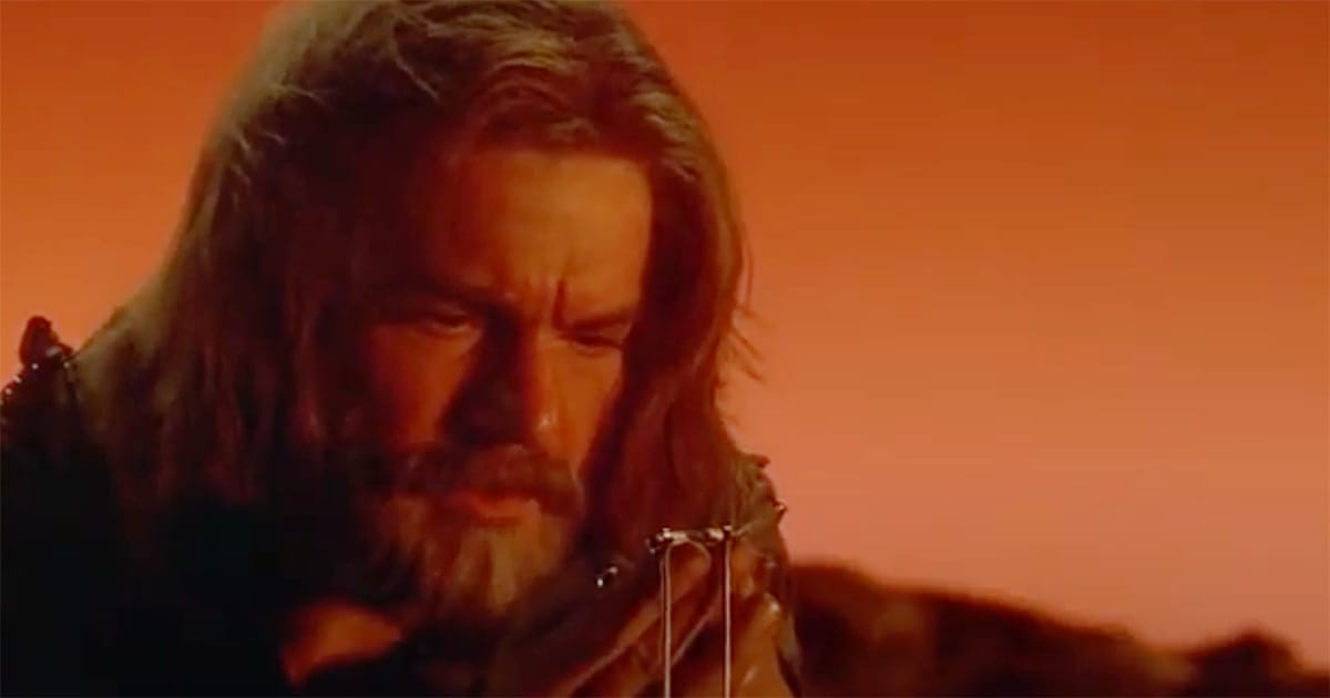 Davidge studies the Drac lineage book against the sunset on Fyrine IV in "Enemy Mine," contemplating his vow to honor Jeriba’s heritage.