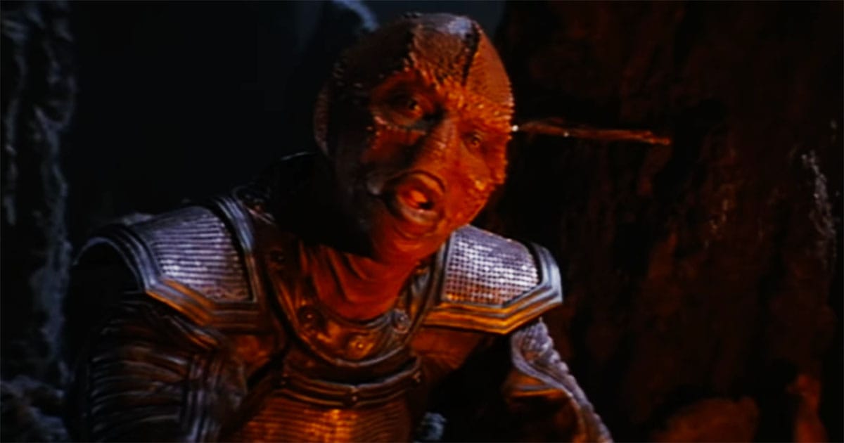 Jeriba Shigan, injured and wearing armor, speaks inside a cave near the end of his life in "Enemy Mine."