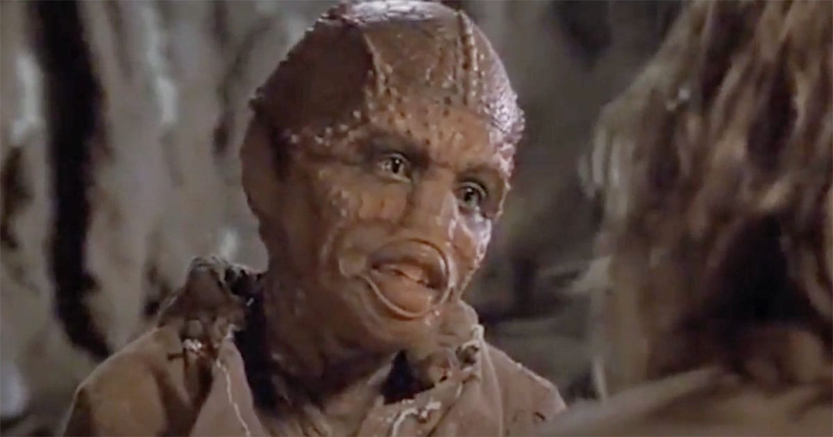 Zammis, the young Drac-human child, looks up at Davidge while speaking inside a cave on Fyrine IV in "Enemy Mine."