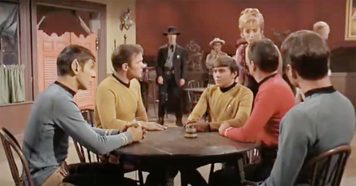 "Star Trek" crew sits in a surreal Western saloon during the episode "Spectre of the Gun"