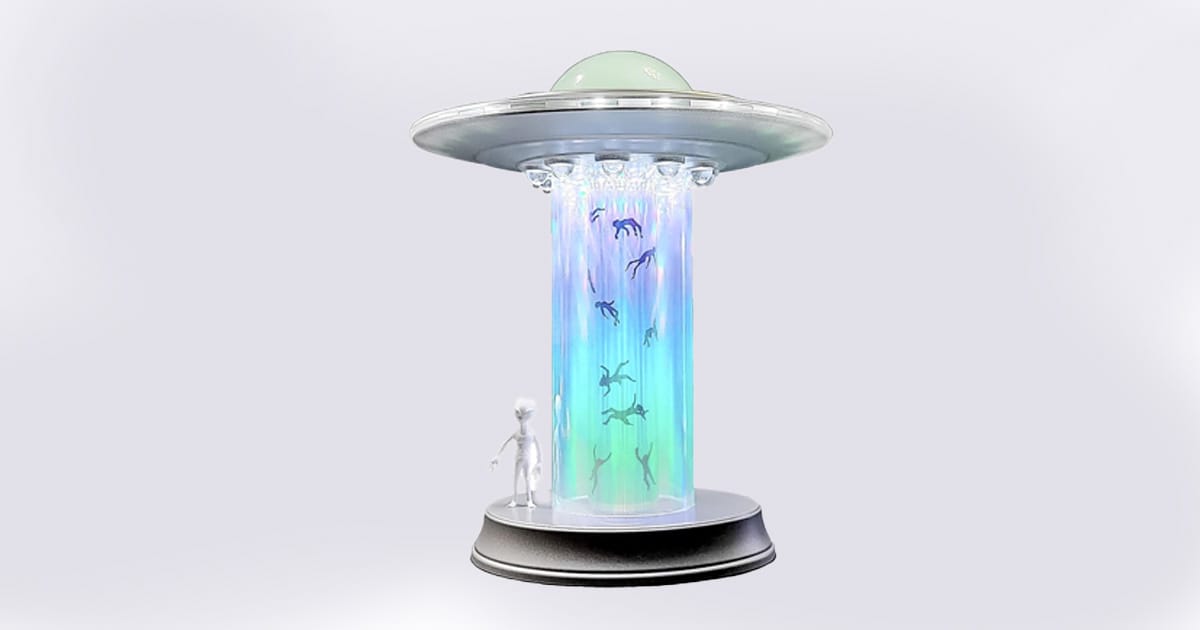 UFO-shaped LED table lamp with glowing rainbow tractor beam and floating abducted figures in transparent cylinder