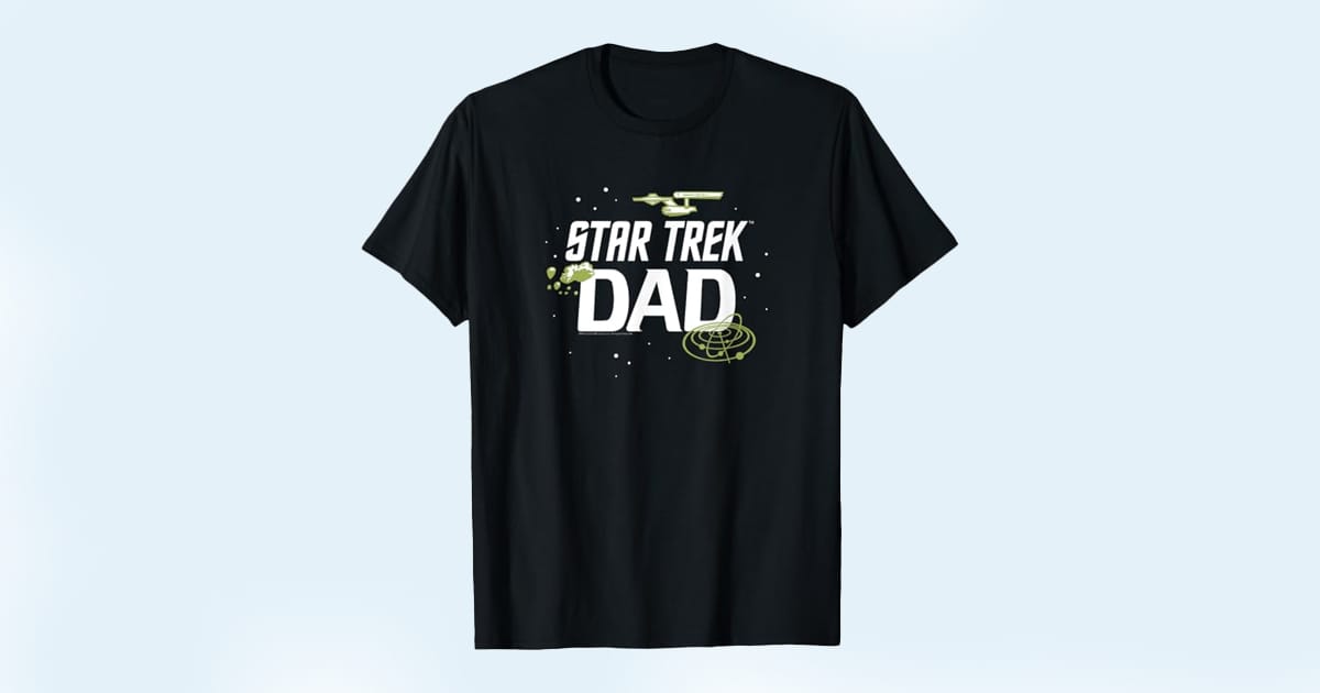Black T-shirt with green and white text reading "Star Trek Dad" and illustrations of the USS Enterprise and space elements