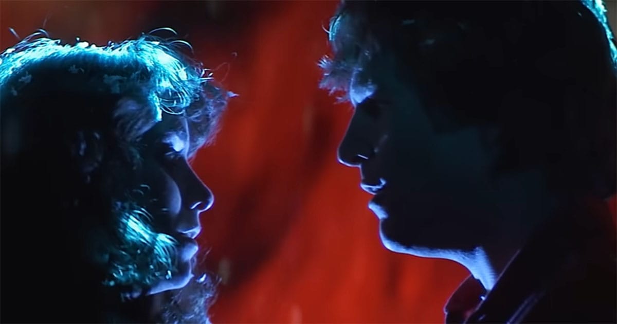 Close-up of Jeff Bridges and Karen Allen in "Starman" facing each other in dramatic lighting, symbolizing the film’s final message about personal connection and quiet understanding.