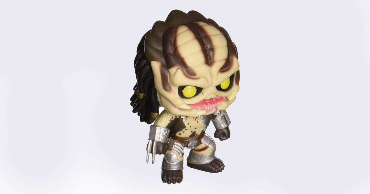Funko Pop Predator vinyl figure with exaggerated head, yellow eyes, and stylized armor, posed on white background.