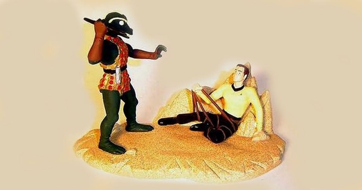 Star Trek diorama featuring Captain Kirk on the ground preparing a weapon while facing the Gorn in a dramatic confrontation from the episode "Arena," set on a rocky desert terrain.