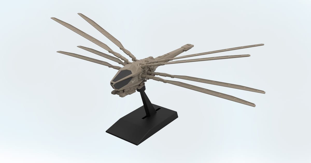 Model of the Atreides Ornithopter from Dune with extended wings displayed on a stand.