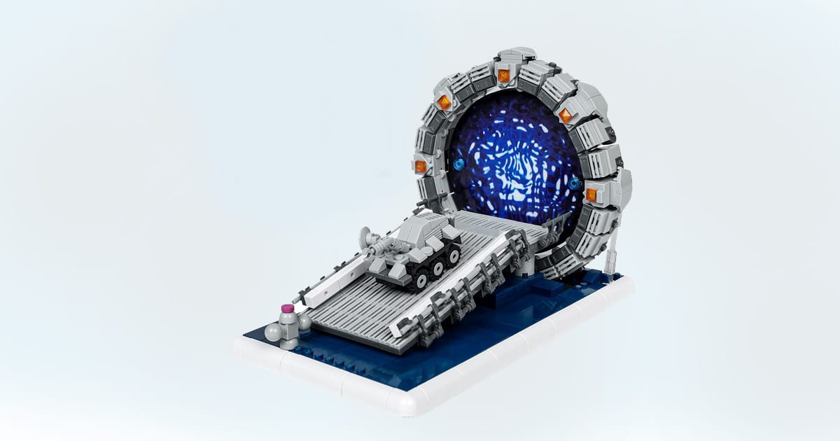Model of a Stargate-inspired building block set featuring a space gate with glowing portal and battle vehicle on ramp.