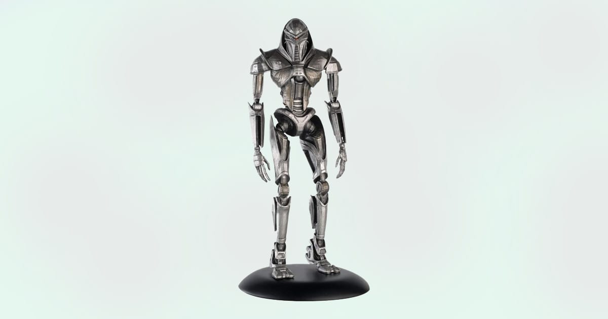 Battlestar Galactica Centurion die-cast figurine on display stand with detailed sculpting.
