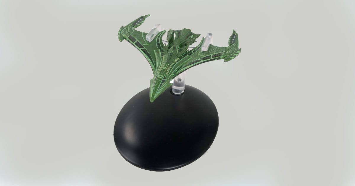 Romulan Vastam-class Command Warbird replica model with green angular hull on display stand.