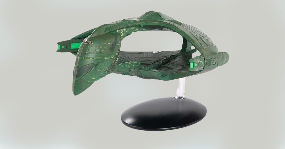 XL Romulan Warbird replica model on display stand, featuring green hull, clamshell design, and elongated neck.