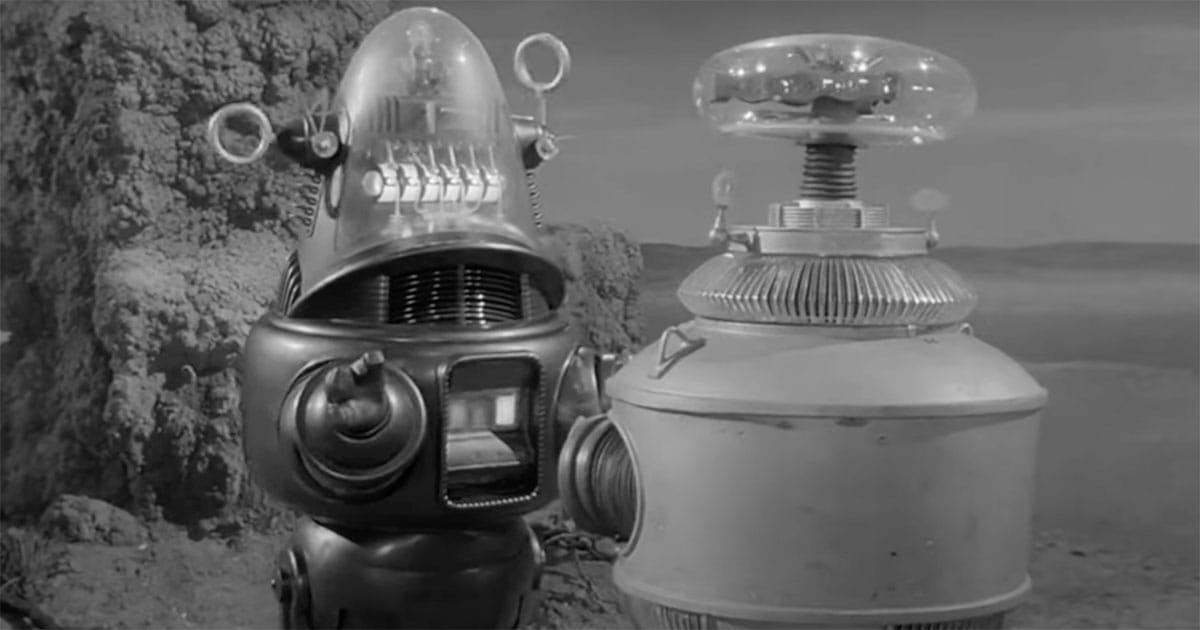 Robby the Robot and the Robot from "Lost in Space" standing side by side on an alien landscape, symbolizing classic science fiction’s exploration of technology’s dual nature.
