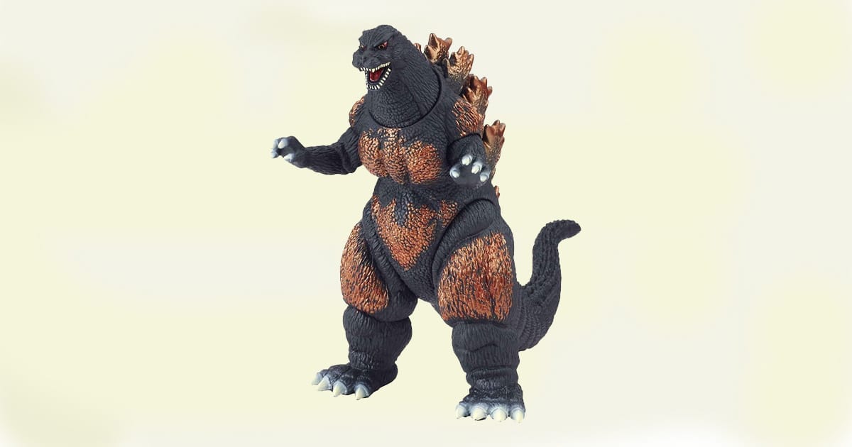 Burning Godzilla action figure with black body and fiery orange highlights, posed upright with detailed dorsal fins.