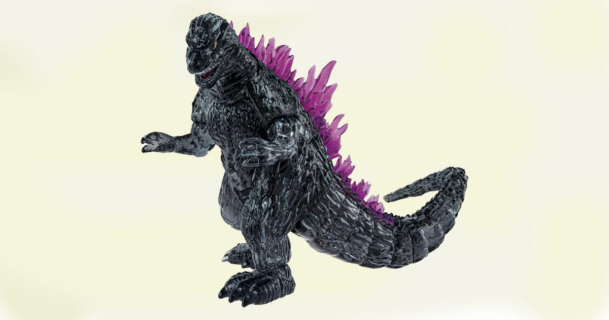 Godzilla action figure with black body and glowing purple spines in dynamic pose.