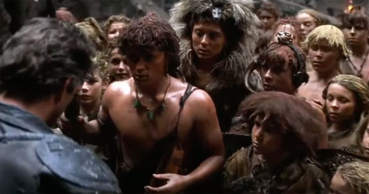 Max Rockatansky stands face-to-face with a group of children who look to him for leadership in Mad Max Beyond Thunderdome