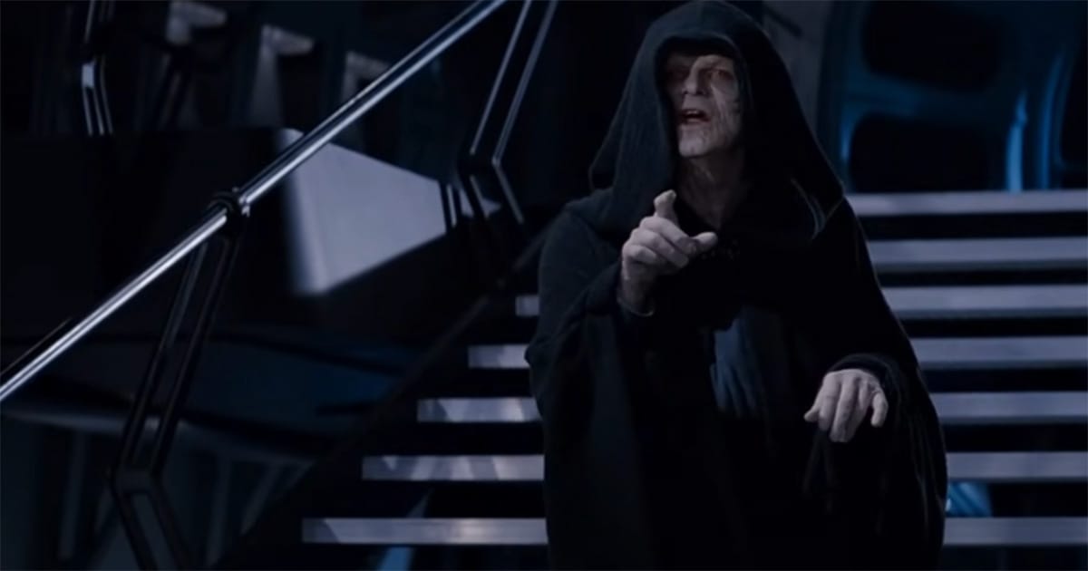 Emperor Palpatine in black robes pointing from atop a metal staircase inside the Death Star throne room in Return of the Jedi (1983)