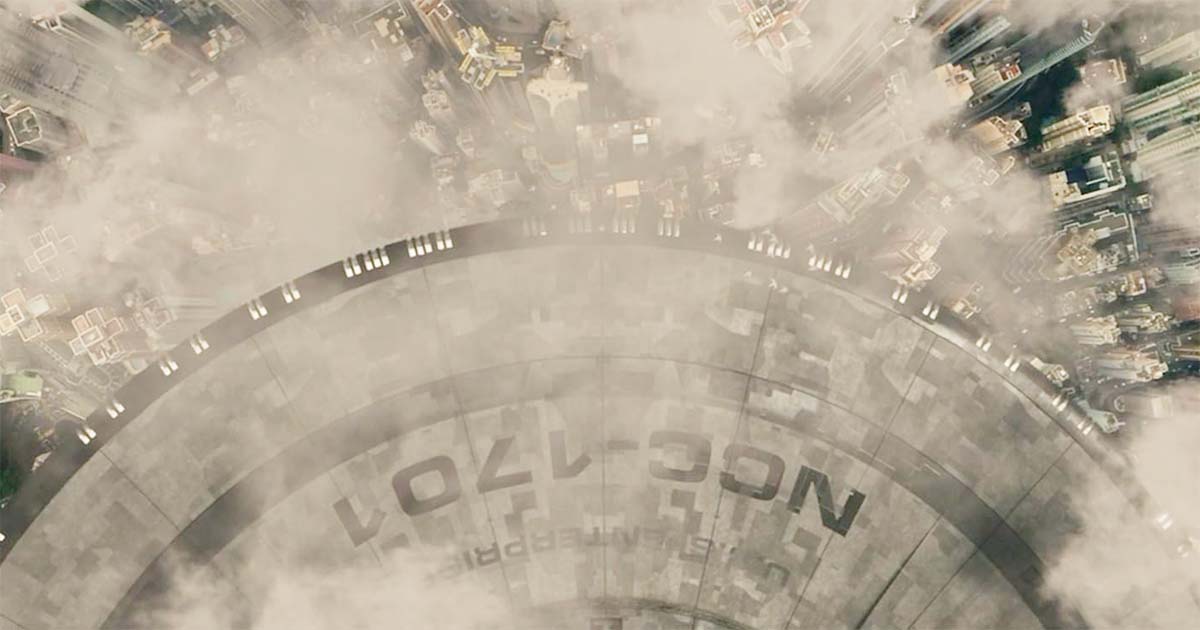 A screen capture from "Strange New Worlds" showing the Enterprise appearing over a pre-warp city.