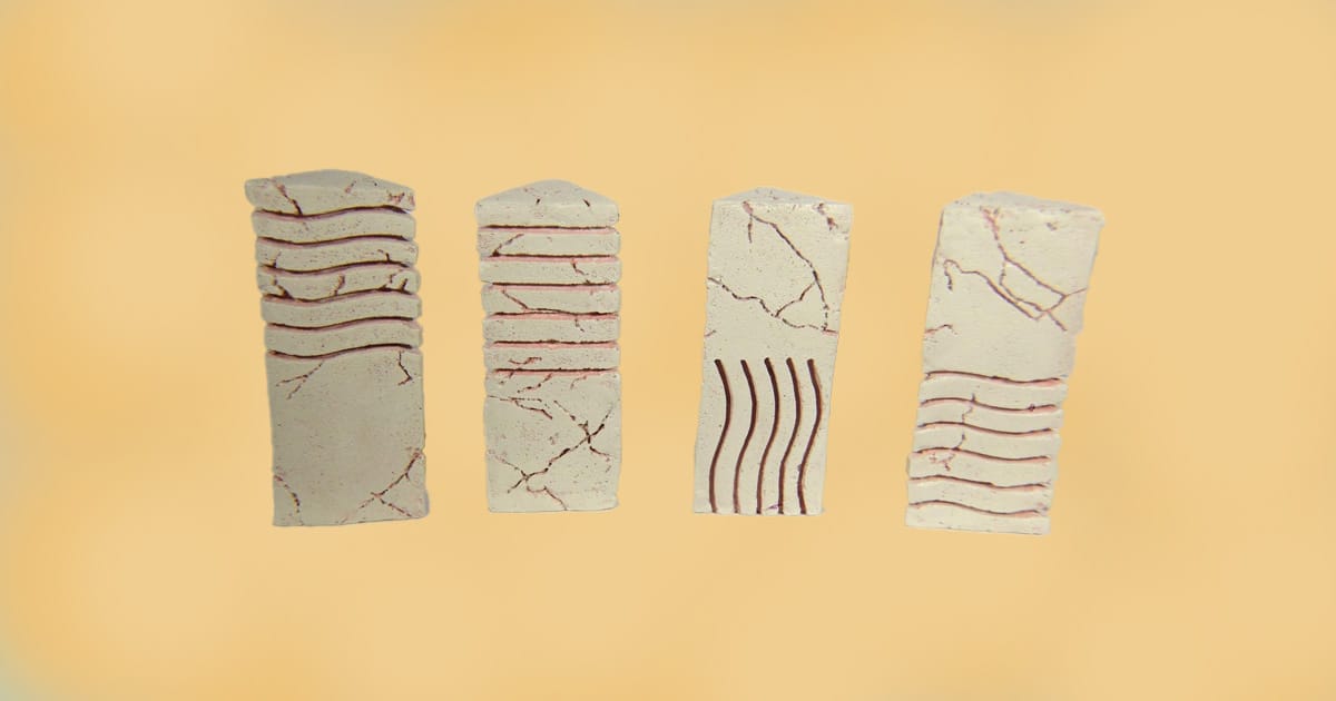 Set of four elemental stone replicas from The Fifth Element with engraved line patterns and weathered finish.