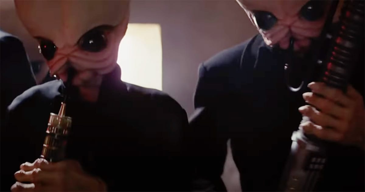 Two Bith aliens from the Star Wars Cantina band playing instruments in a dimly lit scene from "Star Wars: A New Hope."