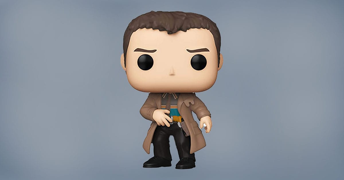 Funko Pop figure of Rick Deckard from Blade Runner wearing trench coat and holding blaster.