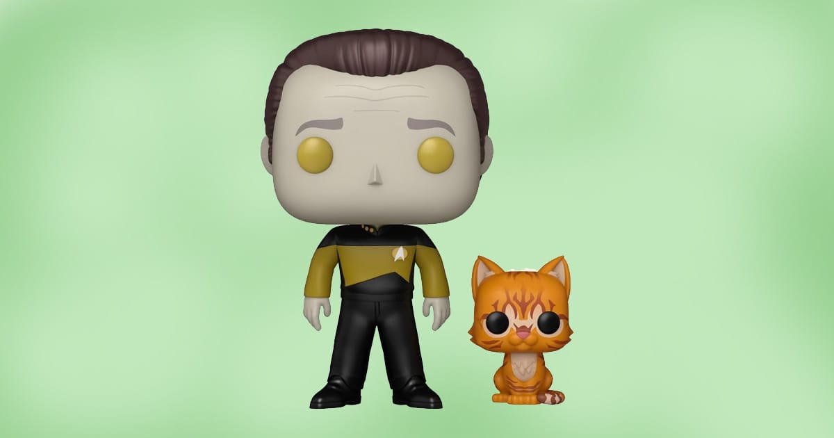 Funko Pop figure of Data from Star Trek: The Next Generation with yellow eyes and Starfleet uniform, standing next to orange cat Spot.