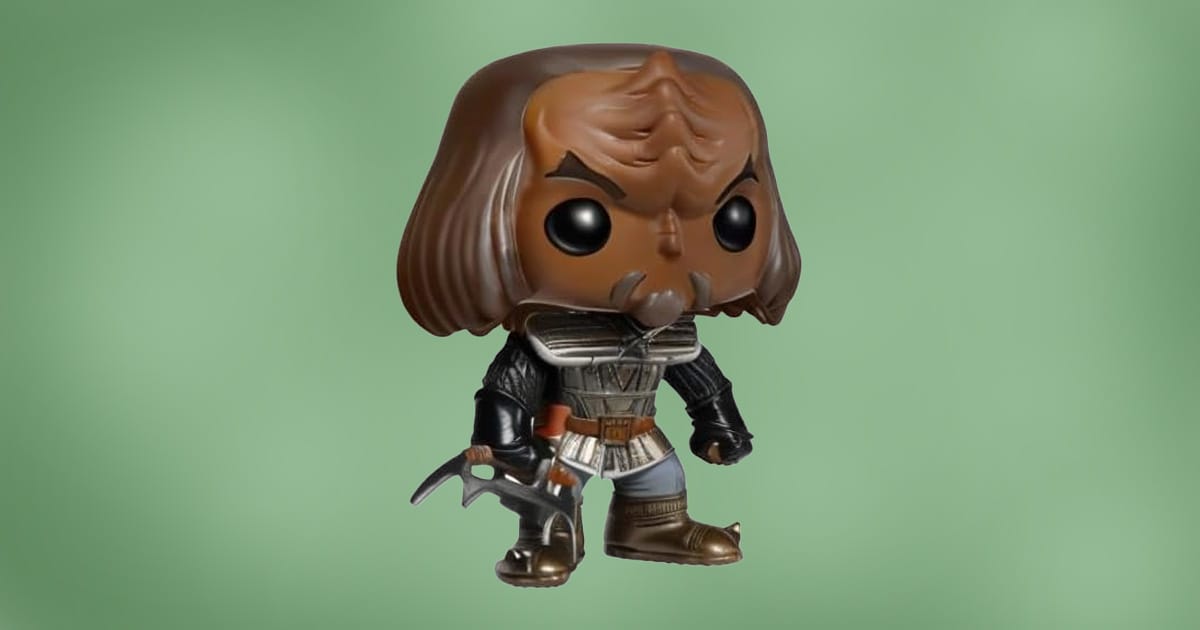 Funko Pop figure of a Klingon warrior from Star Trek: The Next Generation wearing traditional armor and holding a bat’leth, against green background