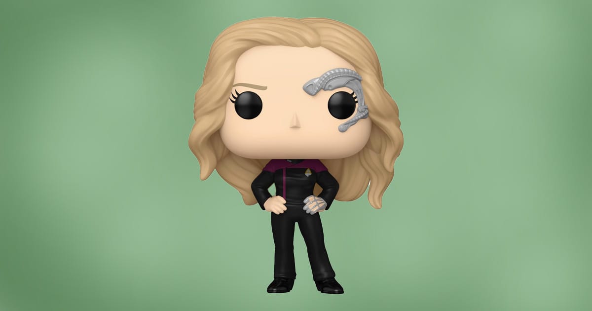Funko Pop figure of Seven of Nine from Star Trek: The Next Generation with cybernetic implant and Starfleet uniform, standing against green background.
